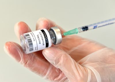 Bottle,With,Vaccine,Against,Covid,19,And,Syringe,In,Hand