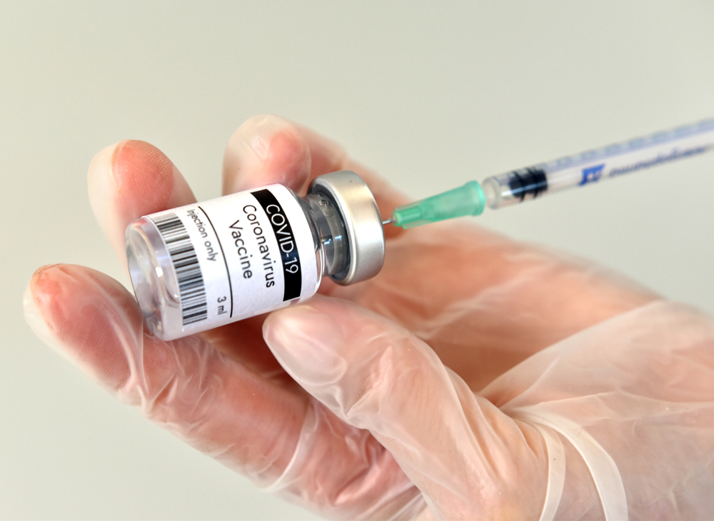 Bottle,With,Vaccine,Against,Covid,19,And,Syringe,In,Hand