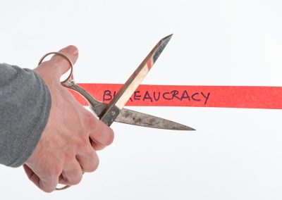 Ron DeSantis Called Out the Federal Bureaucracy Holding Up Florida and Left Donald Trump Out of It Male,Hand,Cutting,Through,Bureaucracy,Red,Tape,With,Scissors,Isolated