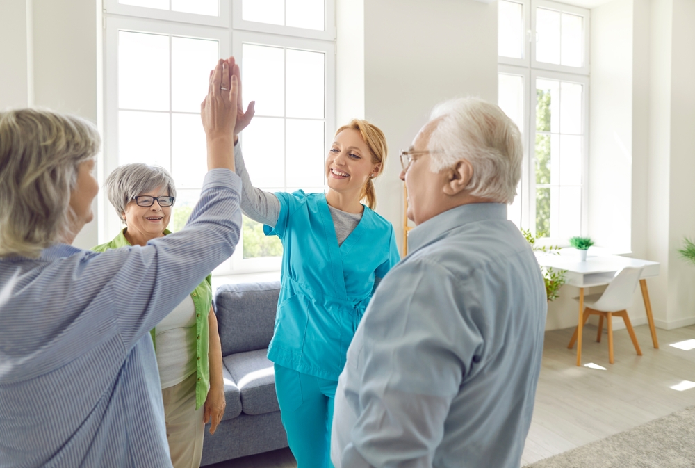 Senior,People,Retirement,Home,Activity,,High,Five,With,Skilled,Nurse,