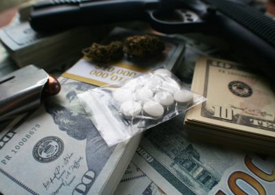Drug,Dealer,Concept,With,Gun,,Pills,,Marijuana,&,Cash